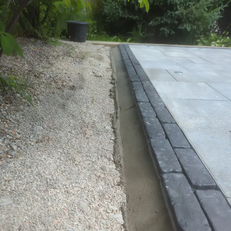 Concrete edge restraint installation for a Permacon Melville patio in Hamilton